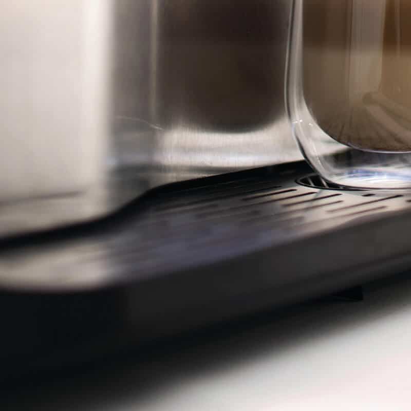 Close up of Azkoyen Coffetek Vitro X3 tray with glass on machine
