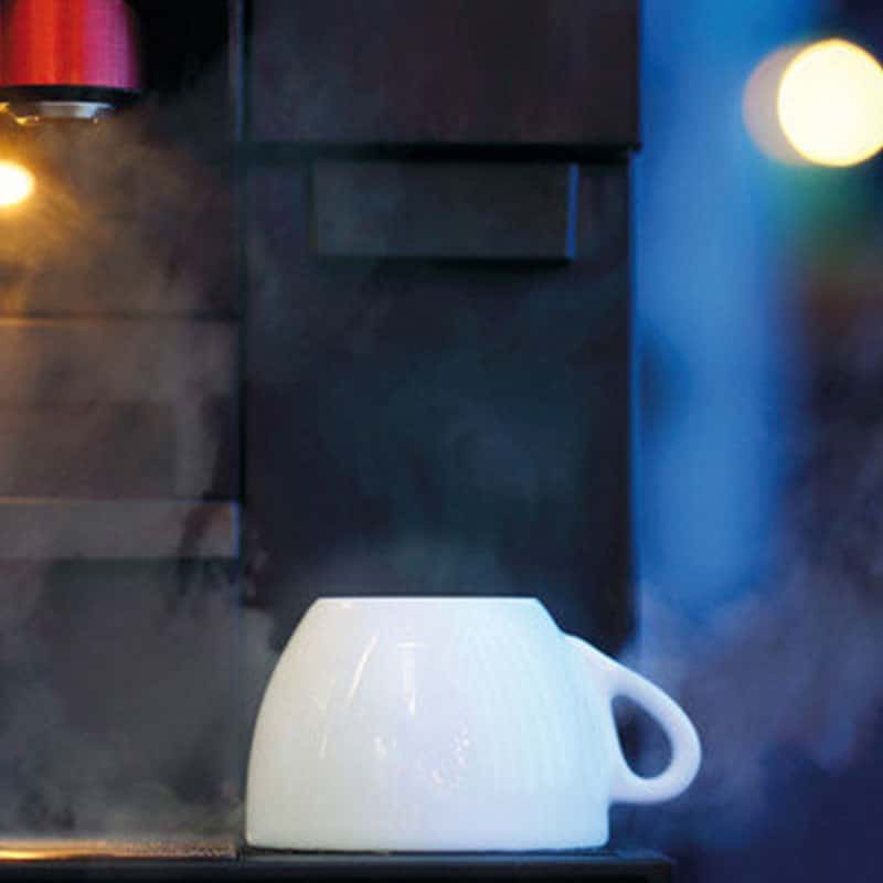 White ceramic mug upside down on a Liquidline Schaerer Club Cup Steamer