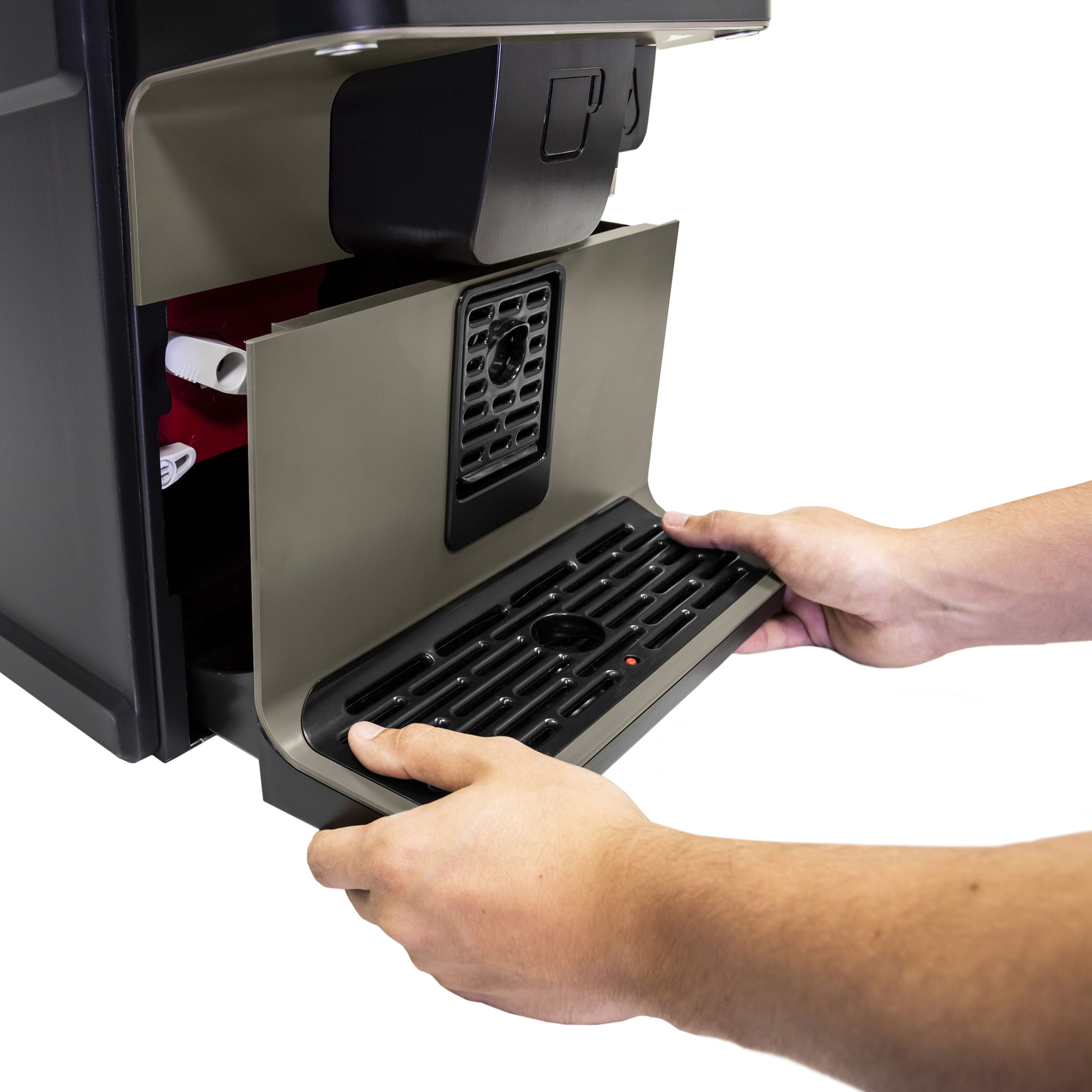 Hands removing a drip tray from under the VITRO X1 AZKOYEN coffee machine.