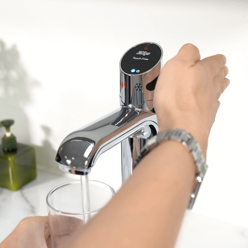 hand activating the sensor to demonstrate usage of the ZIP WAVE machine