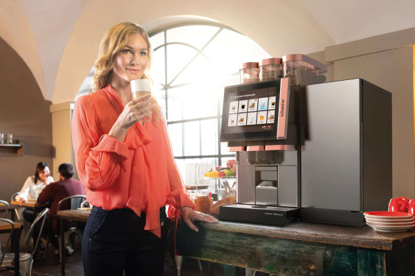 Woman Drinking Coffee At Machine